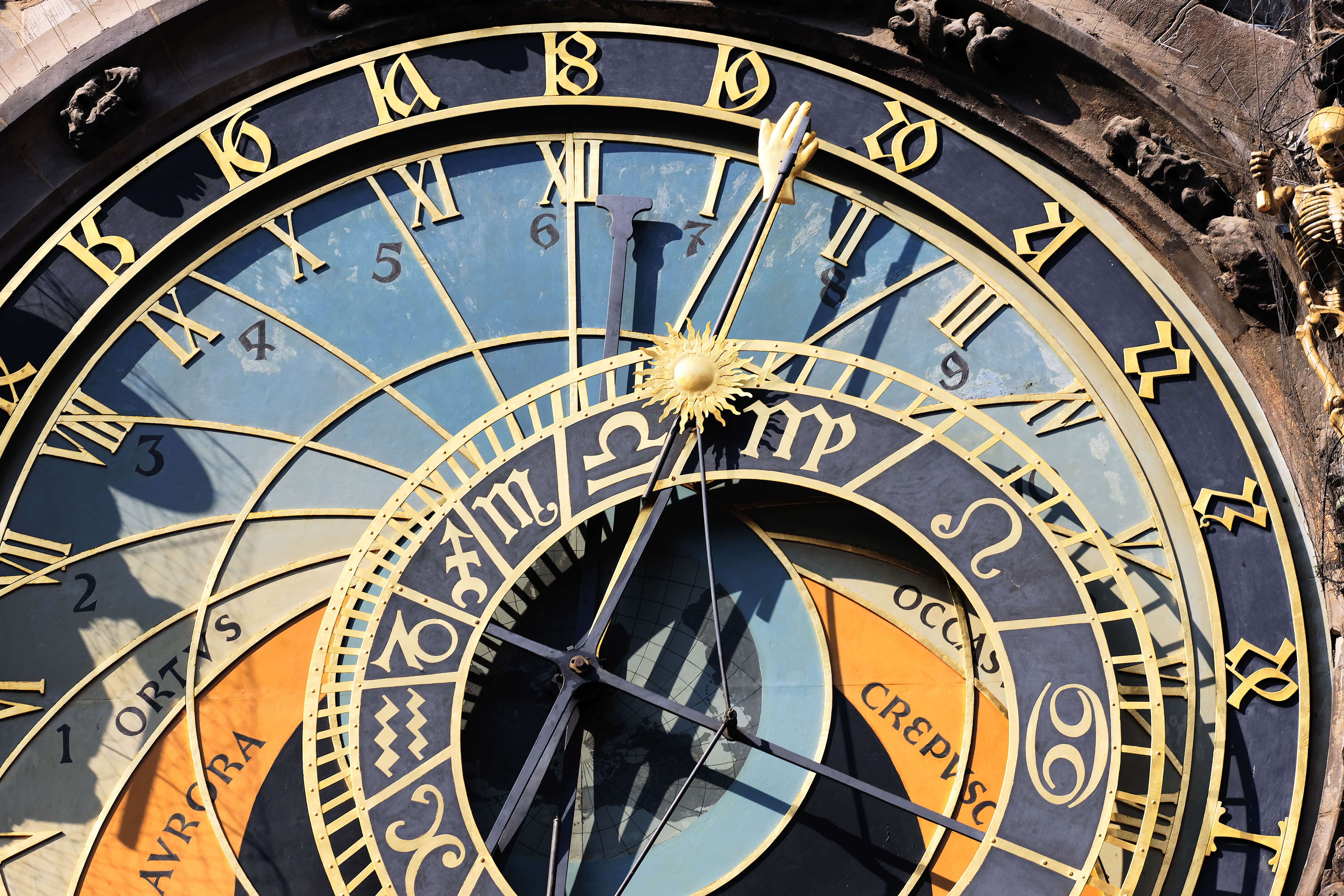 Close-up of Prague's medieval astronomical clock face showing zodiac symbols and Roman numerals